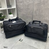 Дорожна сумка чорна на колесах з подвійним дном і висувною ручкою